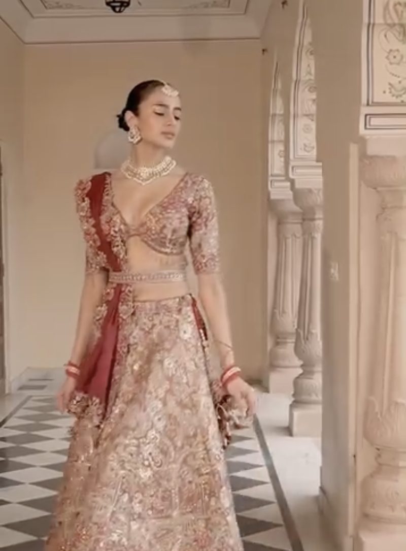 Full-length bridal lehenga in a palace corridor