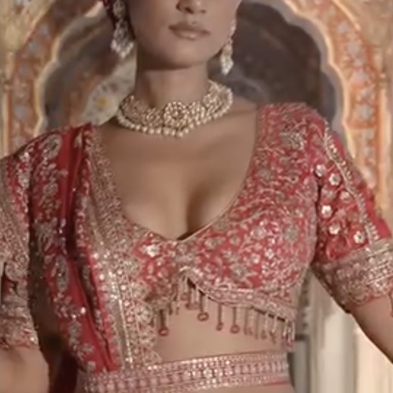 Red bridal lehenga with kundan choker and maang tikka