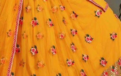 Mustard yellow net lehenga with floral motifs